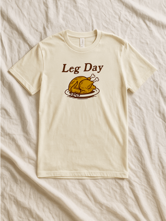The Wishing Elephant Leg Day adult tee featuring a casual cotton t-shirt with a printed graphic design for workout enthusiasts.